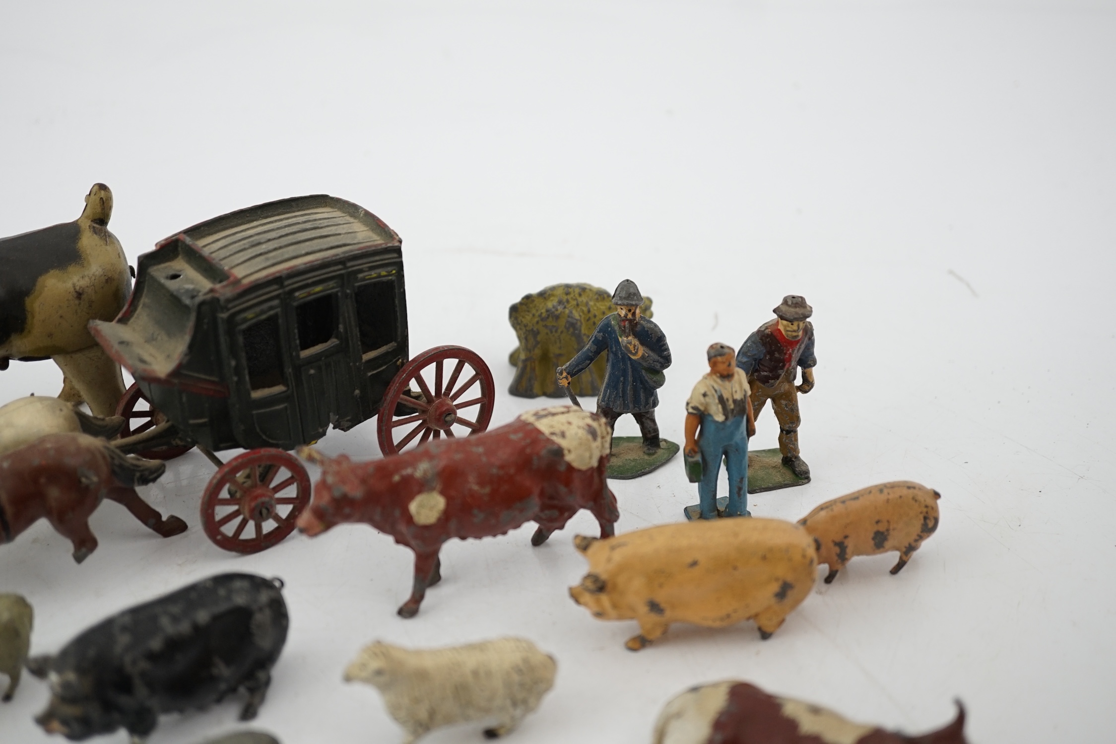 A collection of Britains, etc. lead farm animals and accessories, including the farmer, farmer’s wife, a coach and horses and other figures